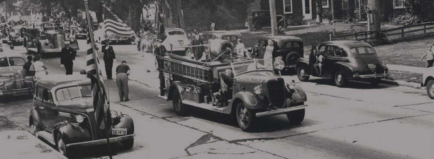 Vintage photo of Mastic FD vehicles in a town parade